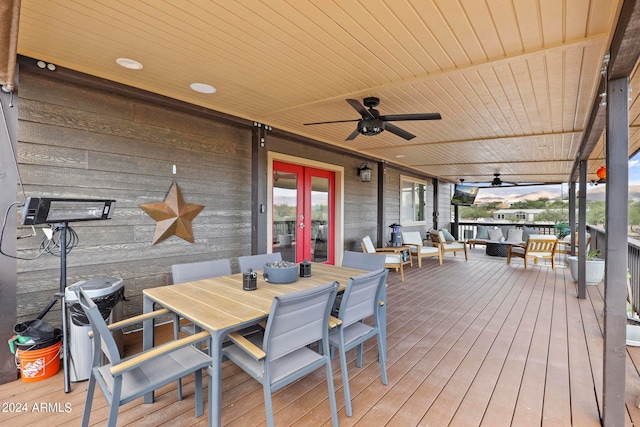 wooden deck with french doors, an outdoor hangout area, and ceiling fan