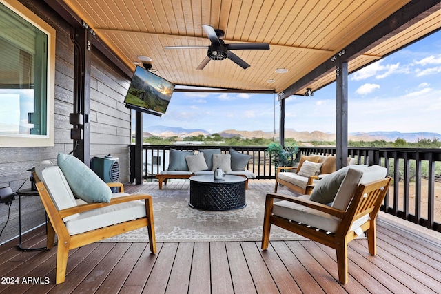 wooden deck featuring outdoor lounge area and ceiling fan