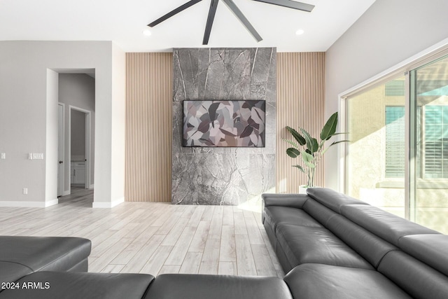 living room with ceiling fan and light wood-type flooring