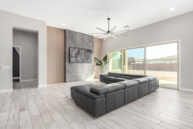 living room featuring light hardwood / wood-style floors and ceiling fan