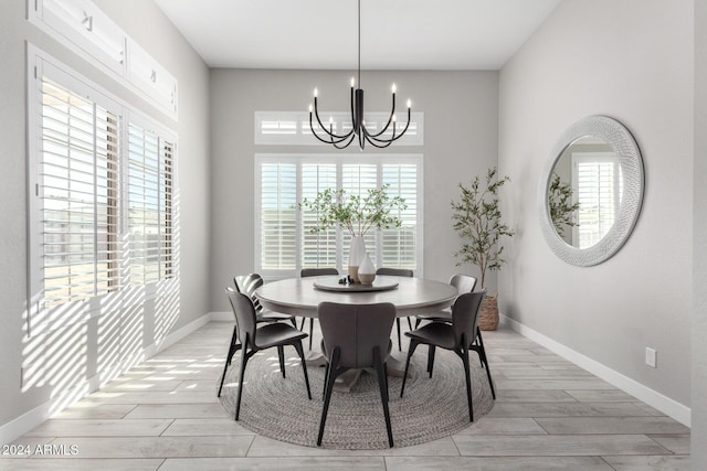 dining room with an inviting chandelier and light hardwood / wood-style floors