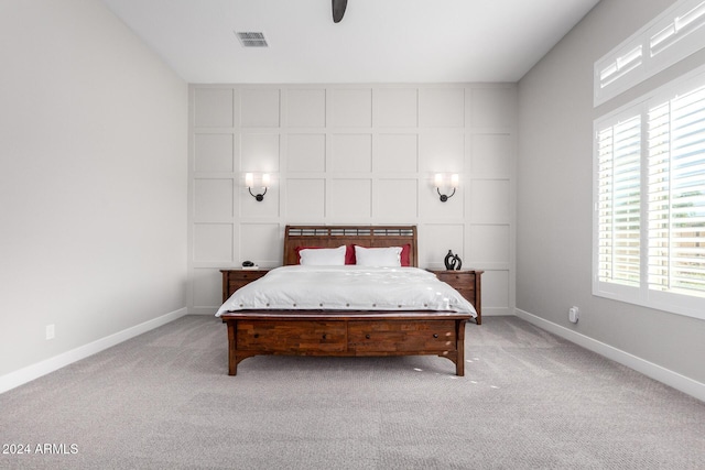 carpeted bedroom with multiple windows