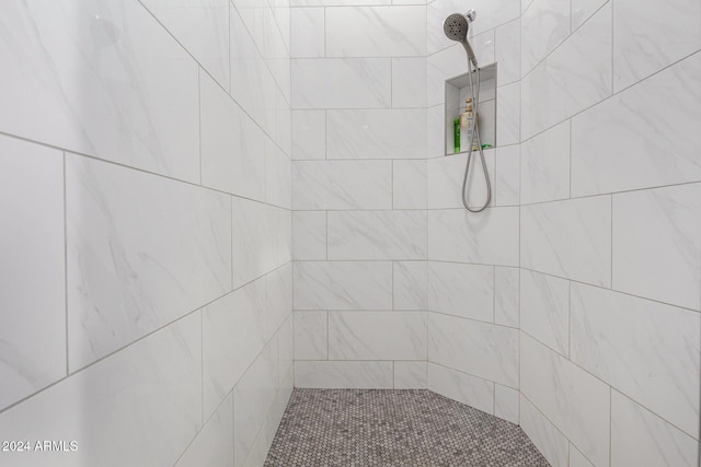 bathroom with a tile shower