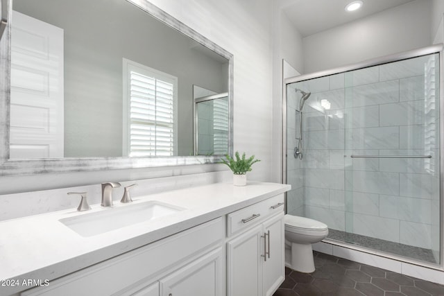 bathroom featuring toilet, an enclosed shower, tile patterned floors, and vanity