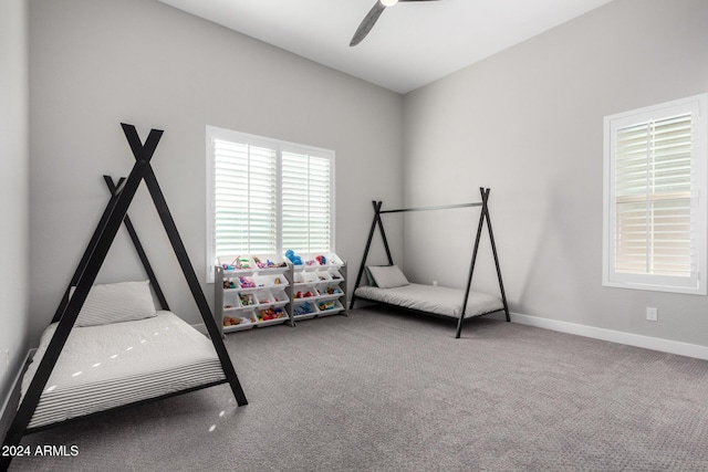 unfurnished bedroom featuring ceiling fan and carpet