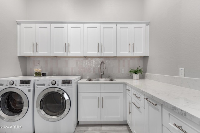 laundry room featuring sink, cabinets, and washing machine and dryer