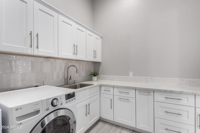 laundry room with washer / dryer, sink, and cabinets