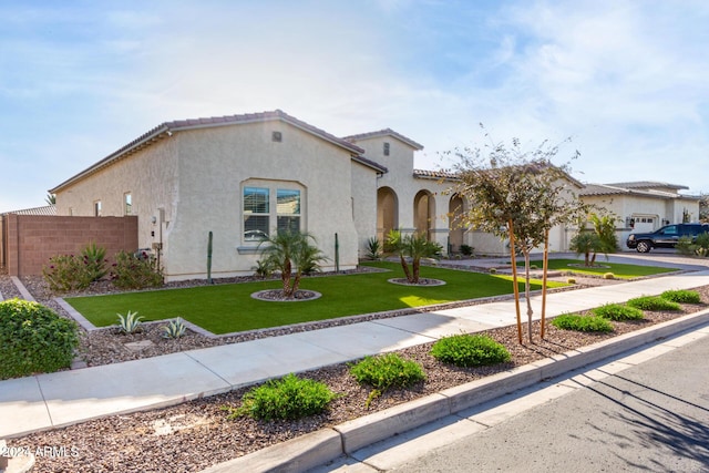 mediterranean / spanish-style home featuring a front yard