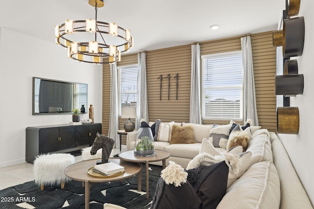 tiled living room with a notable chandelier