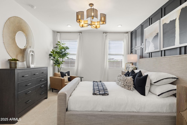 carpeted bedroom featuring a notable chandelier