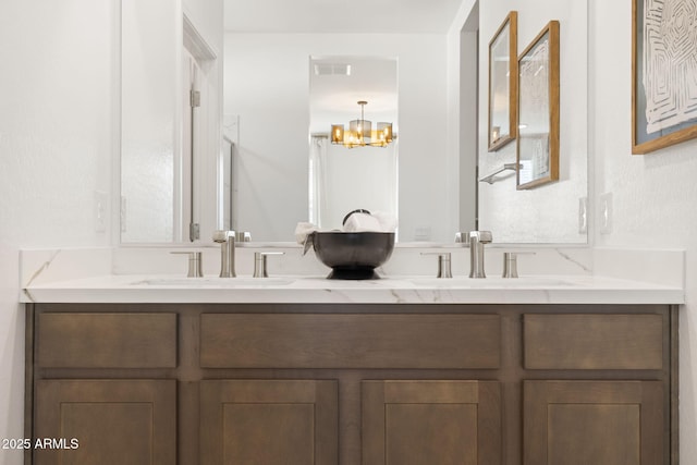 bathroom with vanity and a notable chandelier