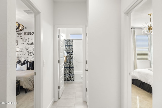 hall with light tile patterned floors