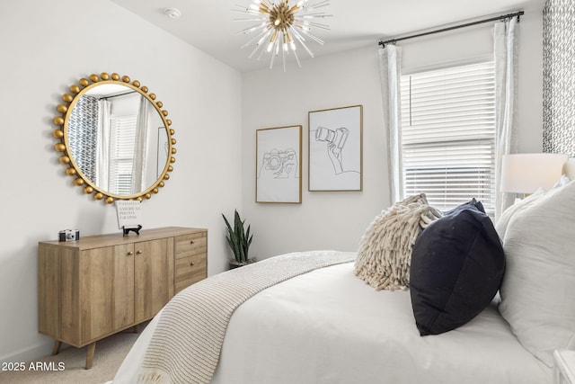 carpeted bedroom featuring a notable chandelier