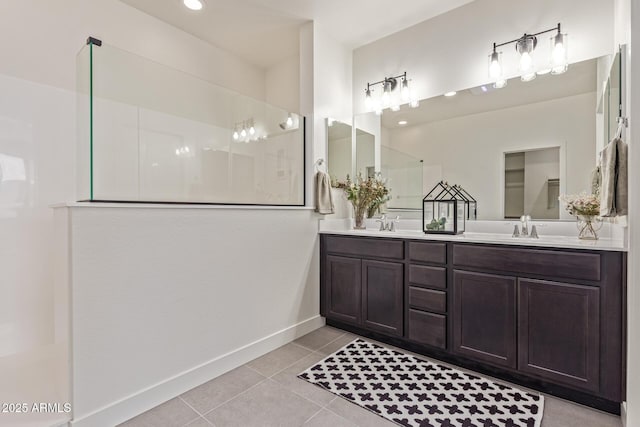 22876 E Via Del Sol, Queen Creek, AZ 85142 - bathroom featuring walk in shower, tile patterned flooring, double vanity, and baseboards