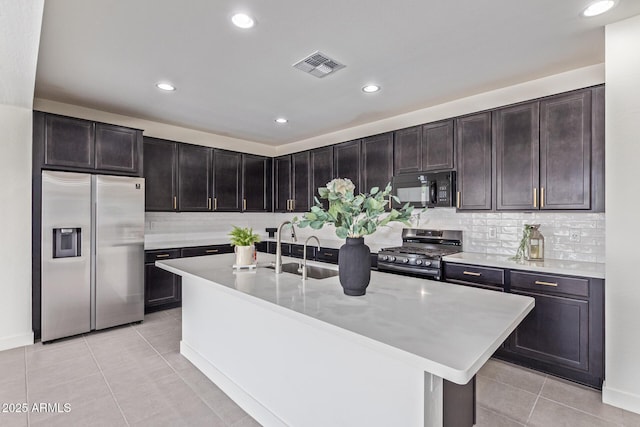 22876 E Via Del Sol, Queen Creek, AZ 85142 - kitchen with appliances with stainless steel finishes, backsplash, light tile patterned floors, a sink, and recessed lighting