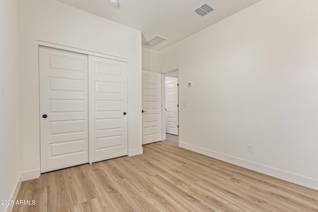 22876 E Via Del Sol, Queen Creek, AZ 85142 - unfurnished bedroom featuring light wood-style flooring, a closet, and baseboards