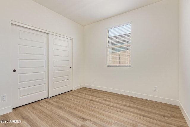 22876 E Via Del Sol, Queen Creek, AZ 85142 - unfurnished bedroom with light wood-style flooring, baseboards, and a closet