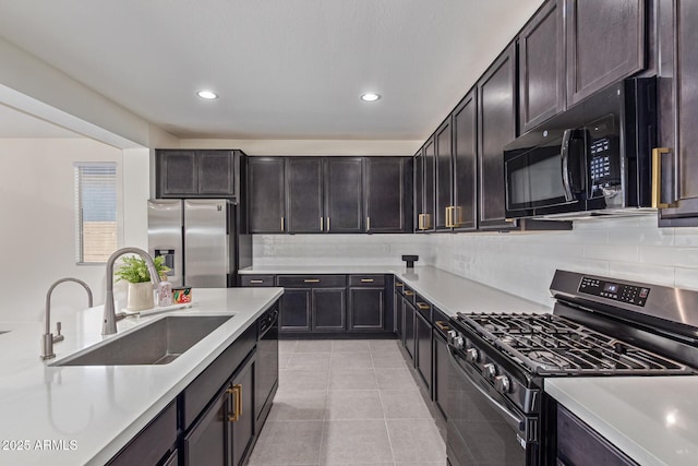22876 E Via Del Sol, Queen Creek, AZ 85142 - kitchen with black appliances, a sink, light countertops, tasteful backsplash, and light tile patterned floors
