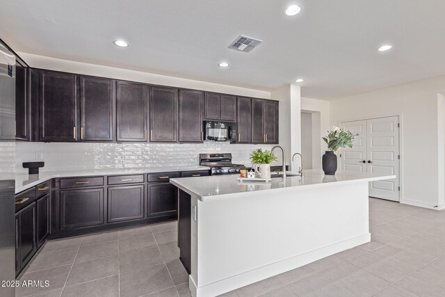 22876 E Via Del Sol, Queen Creek, AZ 85142 - kitchen featuring black microwave, stainless steel gas range oven, backsplash, recessed lighting, and light countertops
