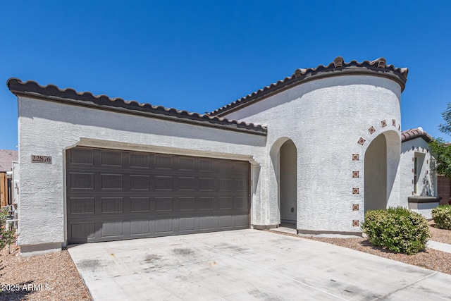 22876 E Via Del Sol, Queen Creek, AZ 85142 - mediterranean / spanish house featuring a tile roof, driveway, stucco siding, and an attached garage