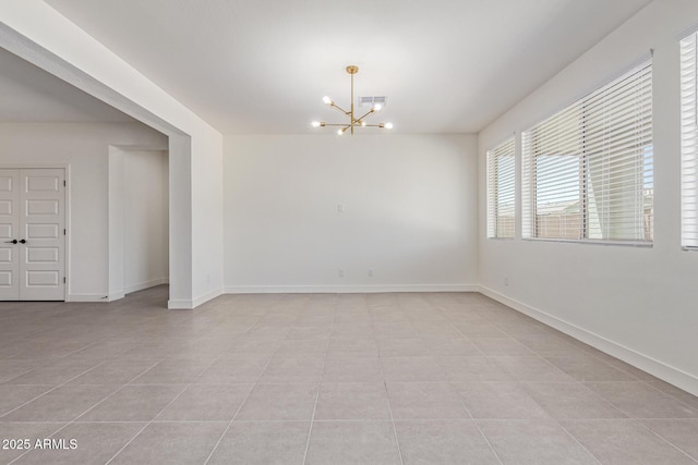 22876 E Via Del Sol, Queen Creek, AZ 85142 - empty room with a chandelier, light tile patterned floors, and baseboards