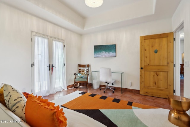 living area with light tile patterned floors, french doors, and a tray ceiling