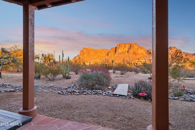 yard at dusk featuring a mountain view