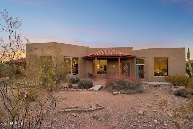 adobe home with a patio area