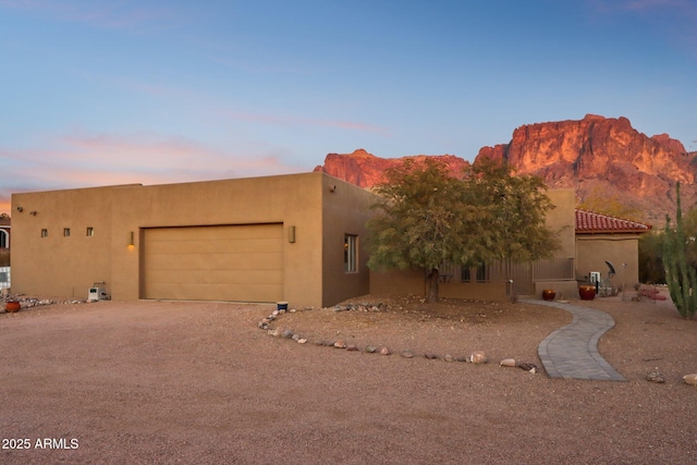 southwest-style home with a mountain view and a garage