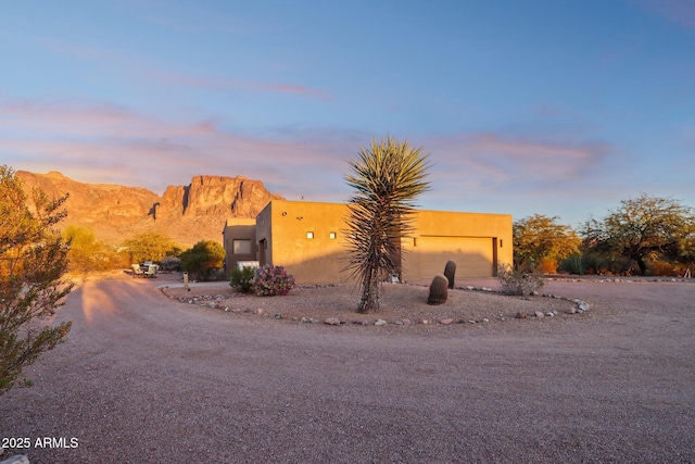 view of front of property with a garage and a mountain view