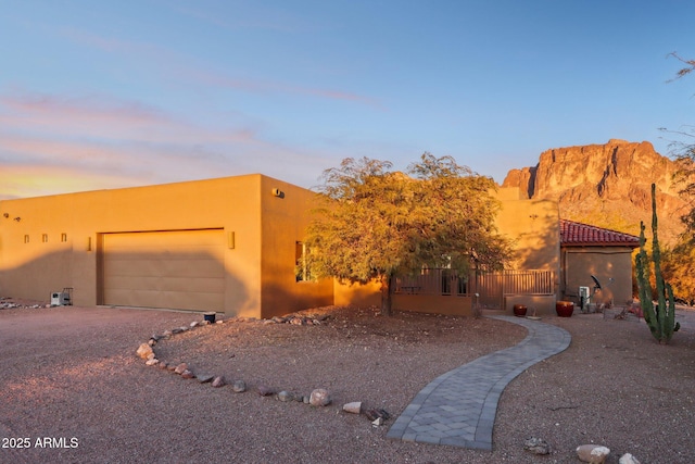 pueblo-style home featuring a garage