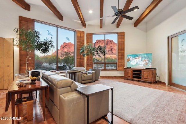 living room featuring beam ceiling and ceiling fan