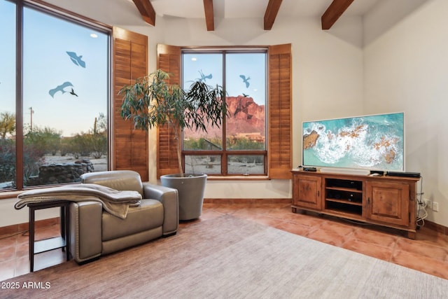 living area featuring light tile patterned floors and beam ceiling