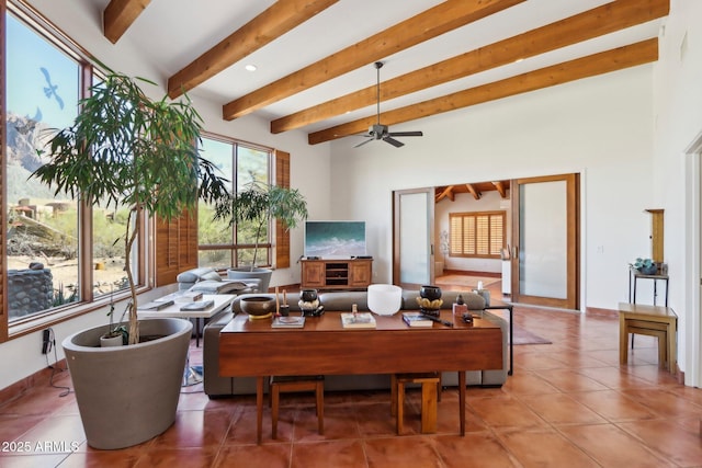 tiled living room with ceiling fan and beam ceiling