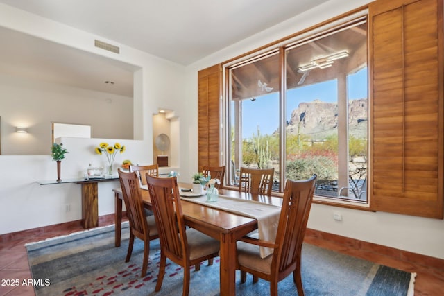 dining area with a mountain view and dark tile patterned floors