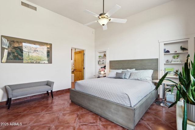 tiled bedroom featuring ceiling fan and a towering ceiling