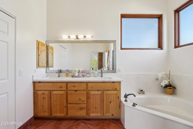 bathroom with vanity, tile patterned floors, and a bathing tub