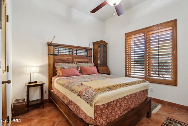 tiled bedroom featuring ceiling fan