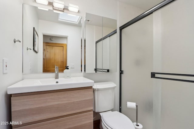 bathroom featuring an enclosed shower, vanity, and toilet