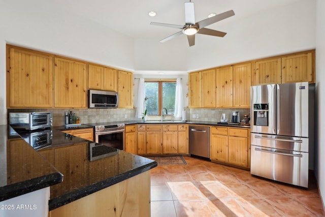 kitchen featuring backsplash, kitchen peninsula, a towering ceiling, and stainless steel appliances