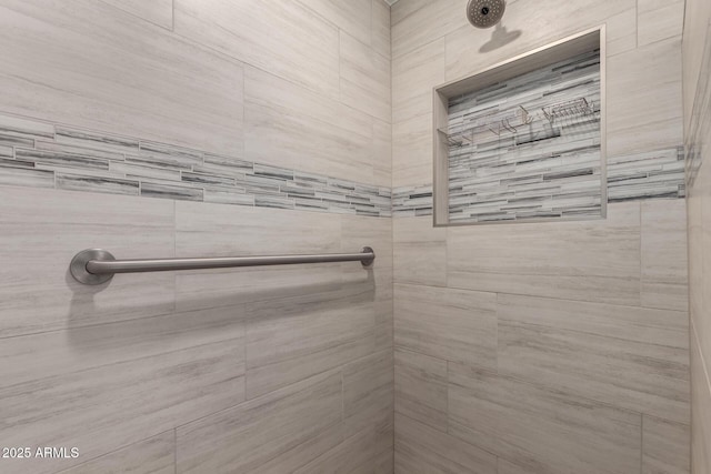 bathroom with a tile shower