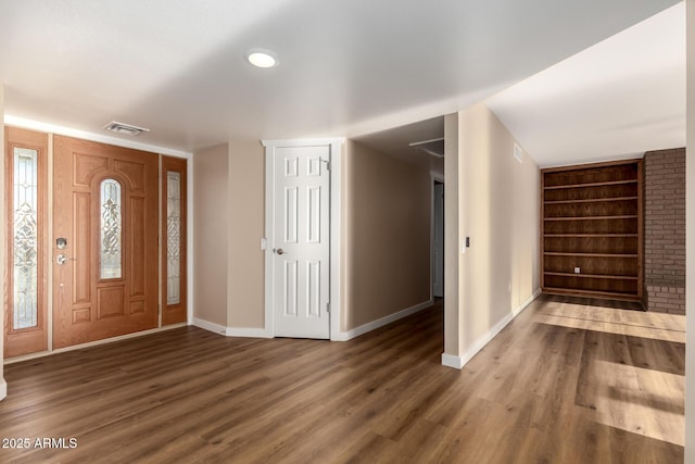 entryway with dark wood-type flooring, visible vents, and baseboards