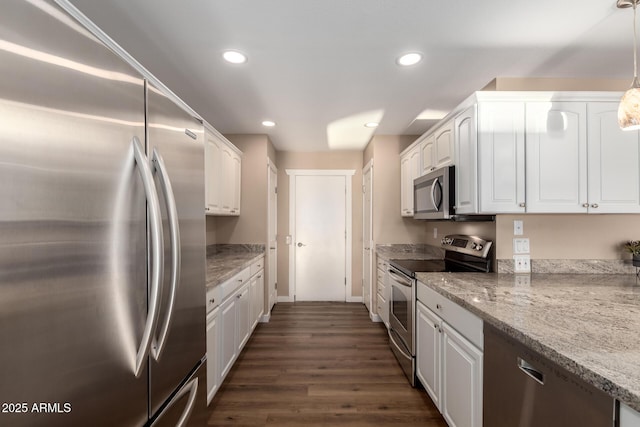 kitchen with light stone counters, decorative light fixtures, stainless steel appliances, recessed lighting, and white cabinets