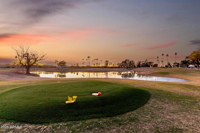 view of home's community with a yard and a water view