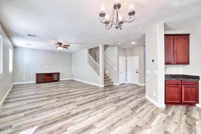 unfurnished living room featuring light wood-type flooring, stairs, and baseboards