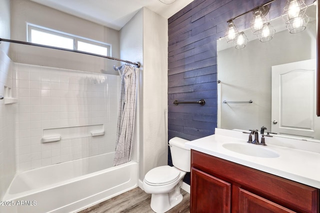 bathroom with wood finished floors, shower / bath combo, vanity, and toilet