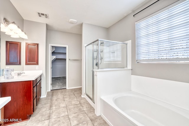 full bath with a garden tub, a stall shower, vanity, and visible vents