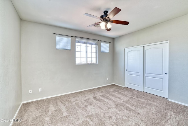 unfurnished bedroom featuring a closet, carpet flooring, and baseboards