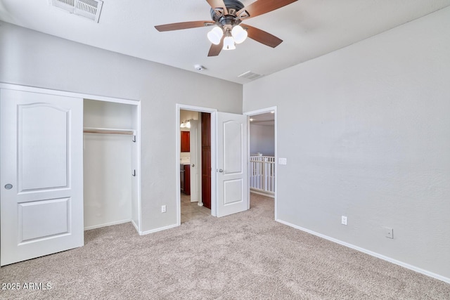 unfurnished bedroom with light carpet, a closet, visible vents, and baseboards