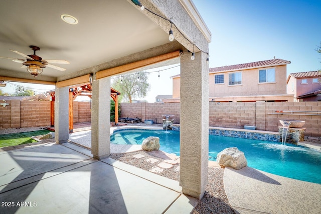 view of swimming pool featuring a patio area, a fenced backyard, ceiling fan, and a fenced in pool